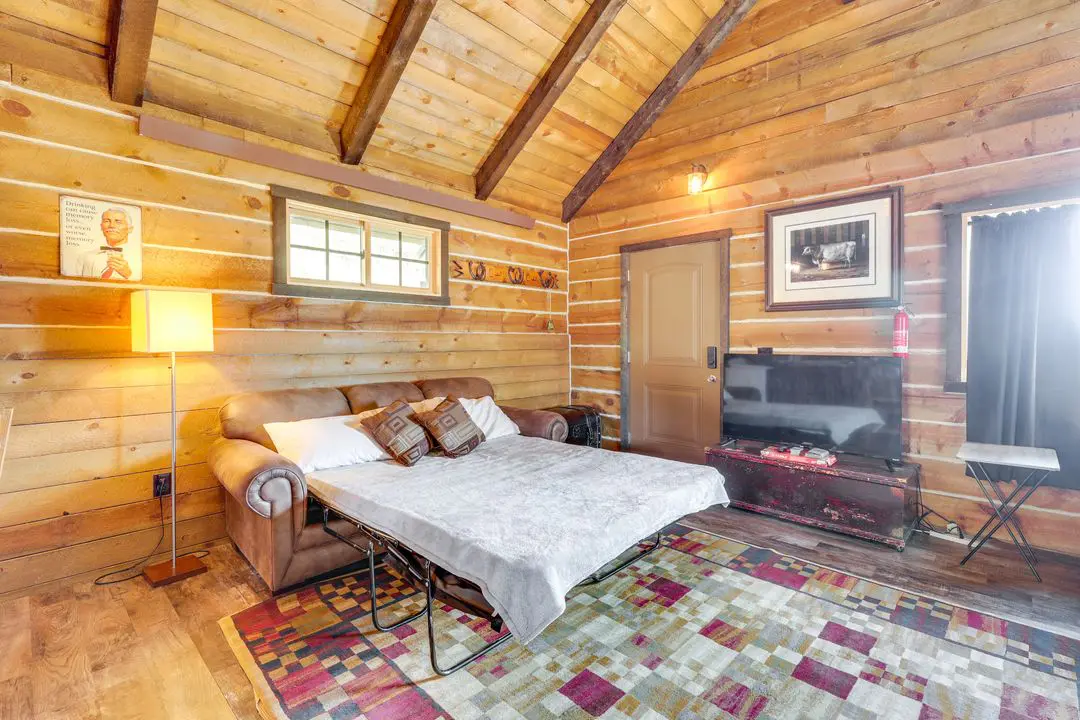 A bed room with a couch and a television
