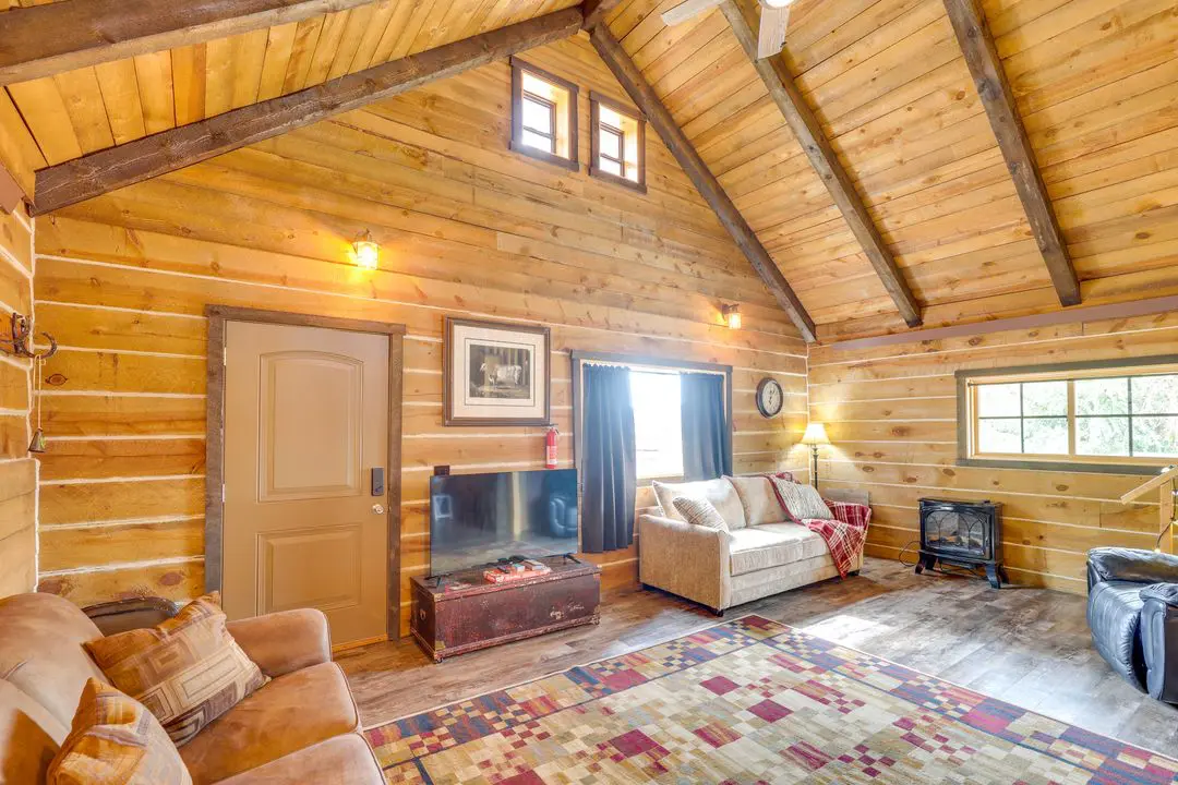 A living room with wood paneled walls and ceiling.