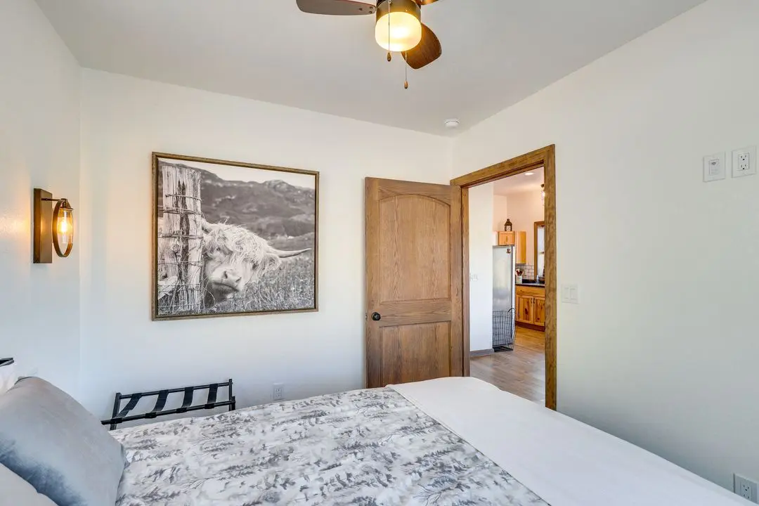 A bedroom with a bed and a painting on the wall.