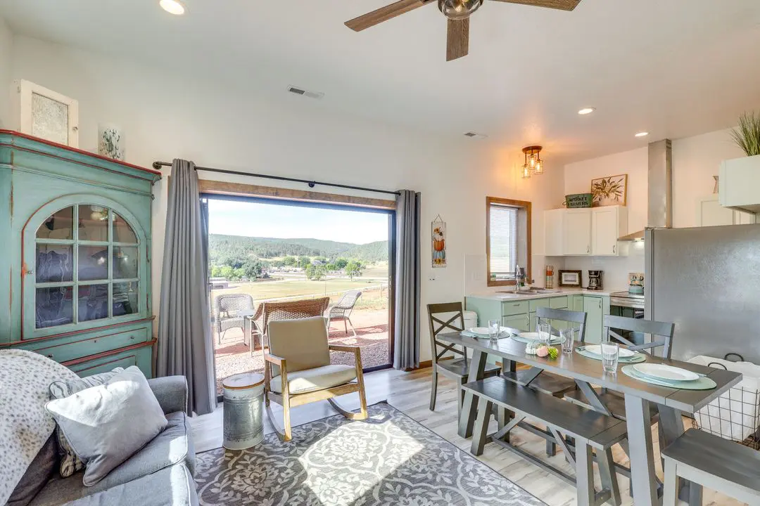 A living room with a sliding glass door open to the patio.